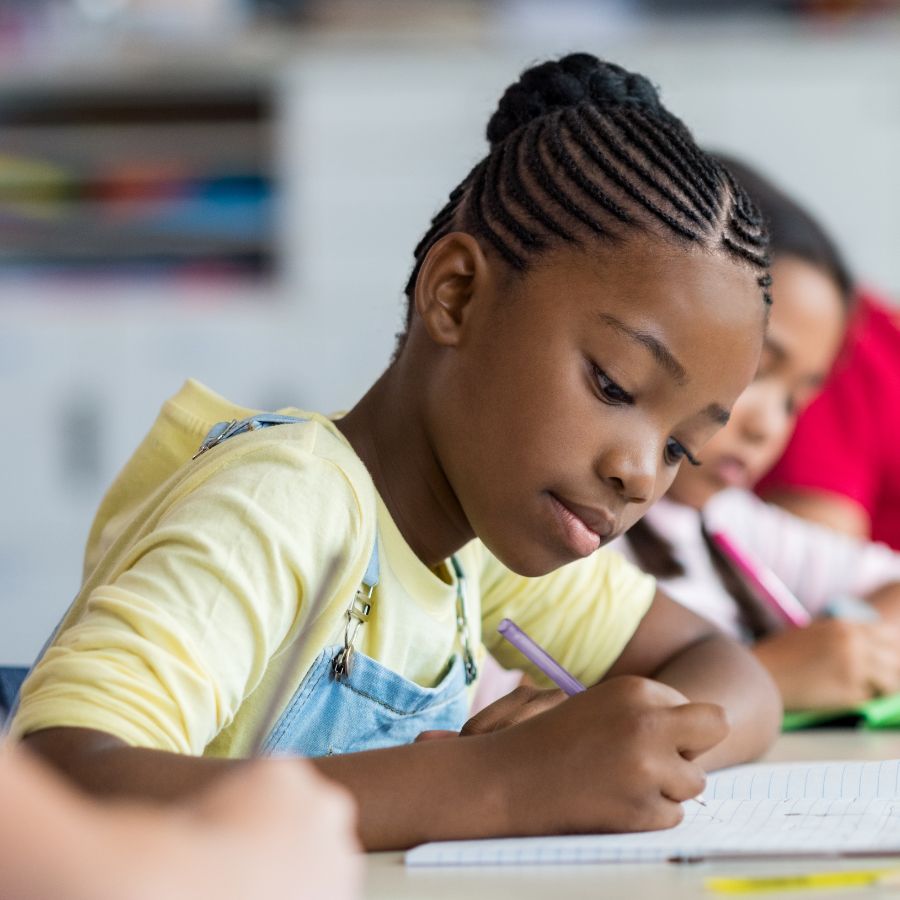 children writing at their desks