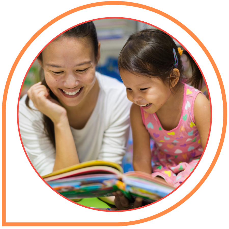 Parent and child reading a picture book together