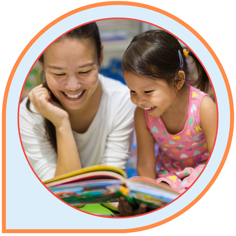 Parent and child reading a picture book together